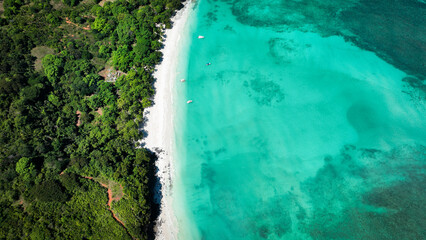 Aerial view of Nosy Iranja Island in Madagascar showcasing pristine beaches, turquoise waters, and lush greenery on a sunny day