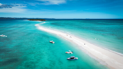 Obraz premium Aerial view of scenic Nosy Iranja Island in Madagascar showcasing turquoise waters and sandy shores frequented by boats and visitors