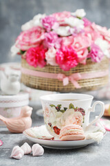 Fototapeta premium Florist at work. How to make floral decorations on summer party table. Centerpiece with rose and carnation flowers. Romantic wedding reception. Step by step, diy.