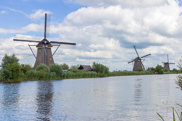 Three windmills from the year 1740 on a row along a canal to protect the low-lands around...
