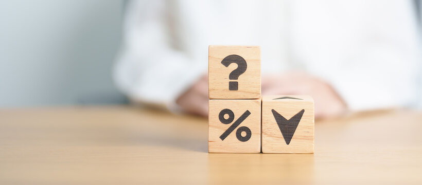 wood block of Question mark with percentage change to UP and Down arrow. Interest rate, GDP, stocks market, financial, deflation and Inflation, ranking, mortgage, debt, Loan and Economic Recession