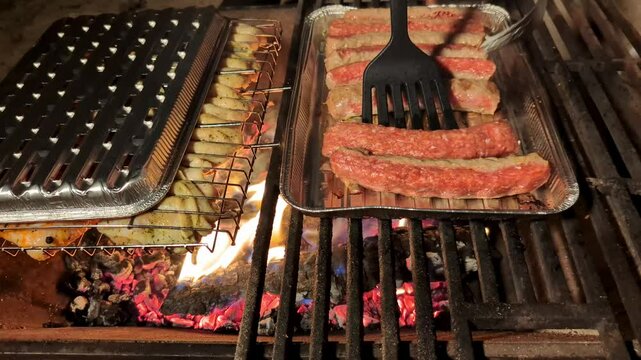 Outdoor Barbecue: Man Cooks Sausages on the Grill