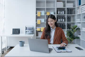 woman meticulously plans a finance audit, using a computer and calculator to review budget...