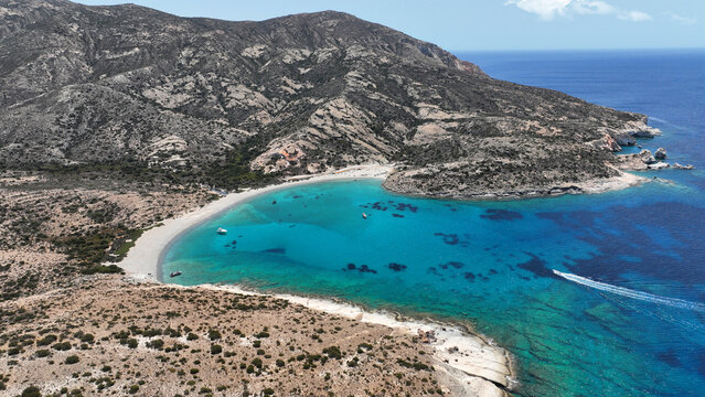 Aerial drone photo of paradise blue bay of uninhabited island of Polyaigos with turquoise crystal clear sea visited by luxury yachts and sail boats resembling a blue lagoon, Cyclades, Greece