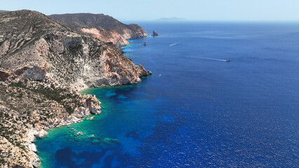 Aerial drone photo of paradise blue bay of uninhabited island of Polyaigos with turquoise crystal clear sea visited by luxury yachts and sail boats resembling a blue lagoon, Cyclades, Greece