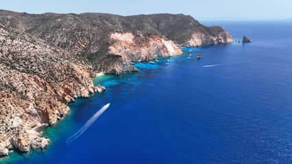 Fototapeta premium Aerial drone photo of paradise blue bay of uninhabited island of Polyaigos with turquoise crystal clear sea visited by luxury yachts and sail boats resembling a blue lagoon, Cyclades, Greece