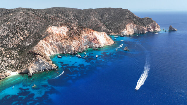 Aerial drone photo of paradise blue bay of uninhabited island of Polyaigos with turquoise crystal clear sea visited by luxury yachts and sail boats resembling a blue lagoon, Cyclades, Greece