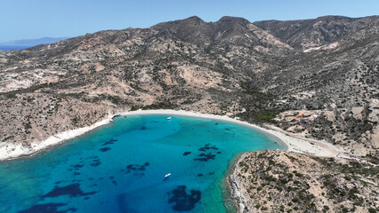 Aerial drone photo from tropical exotic paradise secluded rocky island bay with deep turquoise and...