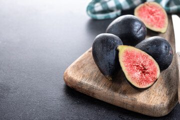 Fresh figs on black slate background. Copy space