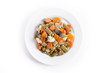 vegetable stew (menestra de verduras) on a plate isolated on white background