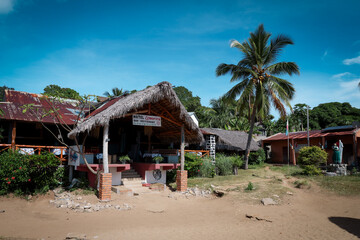 Charming village landscape in Madagascar showcasing local architecture and palm trees under a bright blue sky