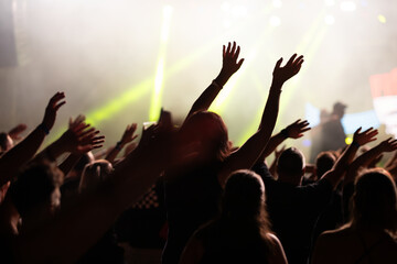 Crowd at concert and colorful stage lights.