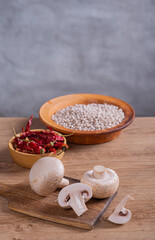 White champignons cut on wooden table in kitchen and white beans