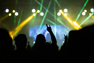 Crowd at concert and colorful stage lights.