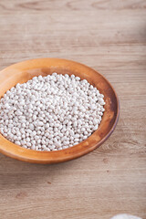 White beans on wooden table in kitchen
