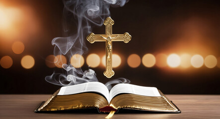 Open bible on a dark background with rays of light and smoke