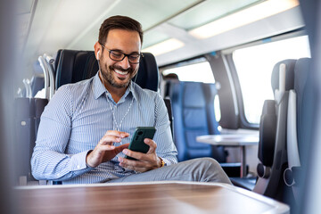 Businessman Enjoying Train Journey While Using Smartphone