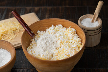 The process of making cottage cheese dough in the kitchen on a wooden table