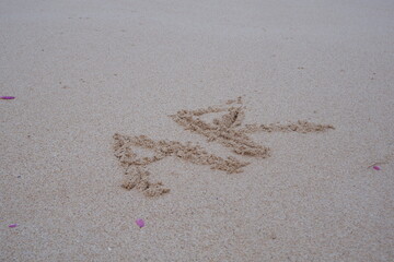 Beach sand with alphabet initials A and R.
