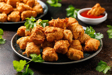 Homemade crispy fried chicken nuggets served with ketchup