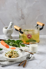 Homemade dumplings in a plate served on kitchen table surrounded with ingredients