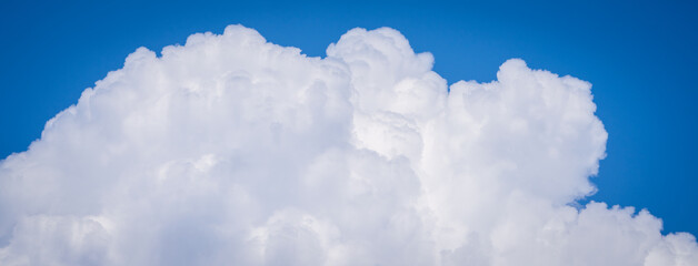 Naklejka premium Rising rain clouds in the blue sky