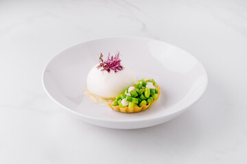 Gourmet appetizer with vegetables and creamy mousse on white plate
