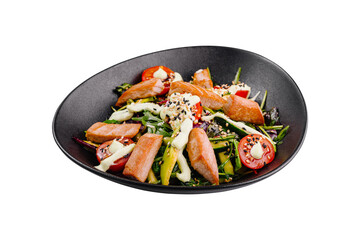 Salmon salad with tomatoes and arugula dressed with creamy sauce in black bowl