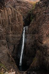 Majestic Waterfall Amid Basalt Columns