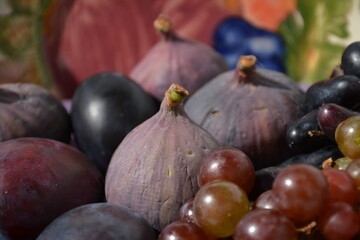 Blue-violet fruits - grapes, plums, figs close-up