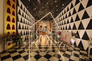 Jaipur, Rajasthan, India Feb 2024 A beautifully decorated event entrance, featuring an illuminated pathway with geometric light structures. 