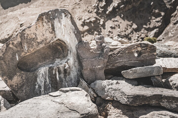 Stone with Buddha imprint on top of Buddhist stupa in Pamir mountains in Tajikistan