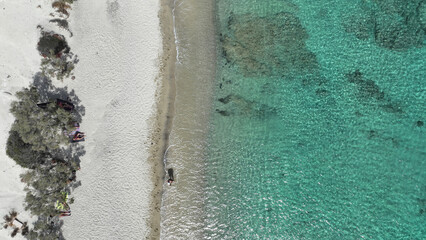Aerial drone photo from tropical exotic paradise secluded rocky island bay with deep turquoise and sapphire sea forming a blue lagoon visited by yachts and sail boats in Caribbean exotic destination
