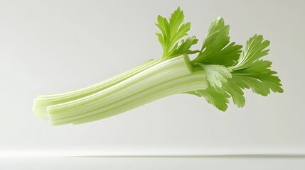 Fototapeta premium 16. **A 3D render of a falling celery stalk, its crisp texture and vibrant green color set against a clean white surface