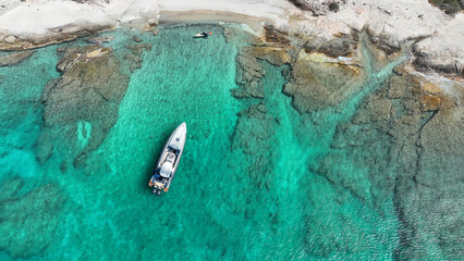 Aerial drone top down photo with copy space of inflatable rib speed boat anchored in tropical...