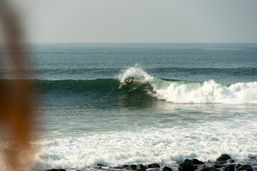 Surfer carving a wave on a sunny day