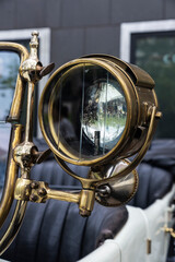 Golden headlight of an old retro car of 1920s