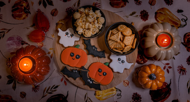 Enchanting Halloween cookies shaped like pumpkins, ghosts, and bats. Decorated with care and set in a warm, mysterious light for a spooky treat.