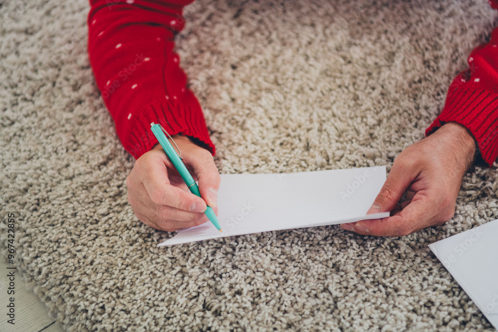 Poster Photo of young man arms hold pen write letter christmas atmosphere apartment indoors