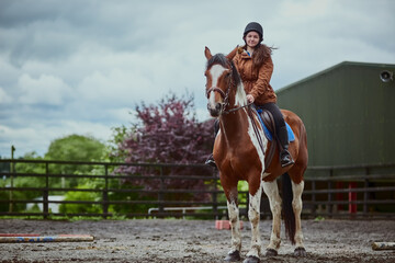Portrait, horse and child riding on farm for sport, countryside training and equestrian...
