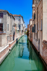Fototapeta premium Venice, Italy. A stunning view of a tranquil canal in Venice, highlighting the beauty of traditional Italian architecture