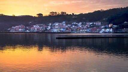 Panoramic view at sunset of the town San Esteban de Pravia and its port. Asturias Spain. © lleandralacuerva