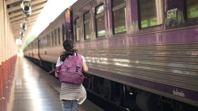 Young woman sprinting to catch a departing train