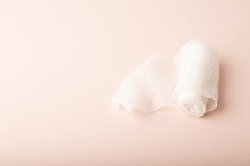 A skein of bandage on pink background top wiev. Treatment wounds. Applying plaster to the fracture. Medical concept banner. Healthcare banner. Copy space. High quality photo
