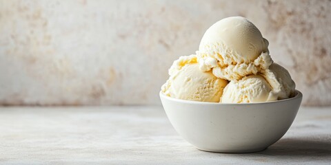Delicious vanilla ice cream scoops in a white bowl against a rustic background, perfect for desserts or sweet treats.