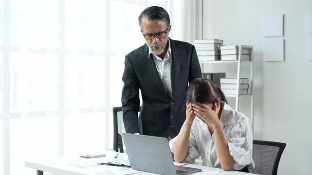 Senior manager scolding crying employee at work