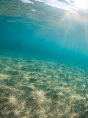 Beautiful sunbeam on the shallow beach underwater.