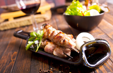 Wine and kebab with spices and vegetables on plate