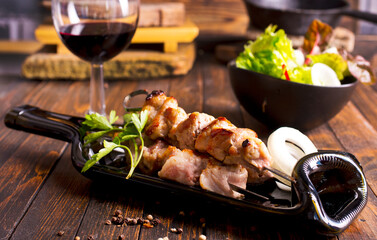 Wine and kebab with spices and vegetables on plate