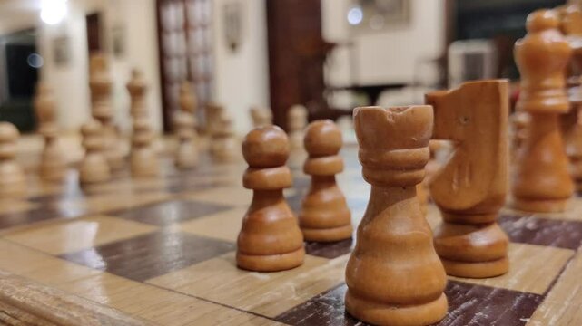 Footage of wooden chess figures on a wooden chess board shot against blur out background. Planning, concept, strategy leadership

